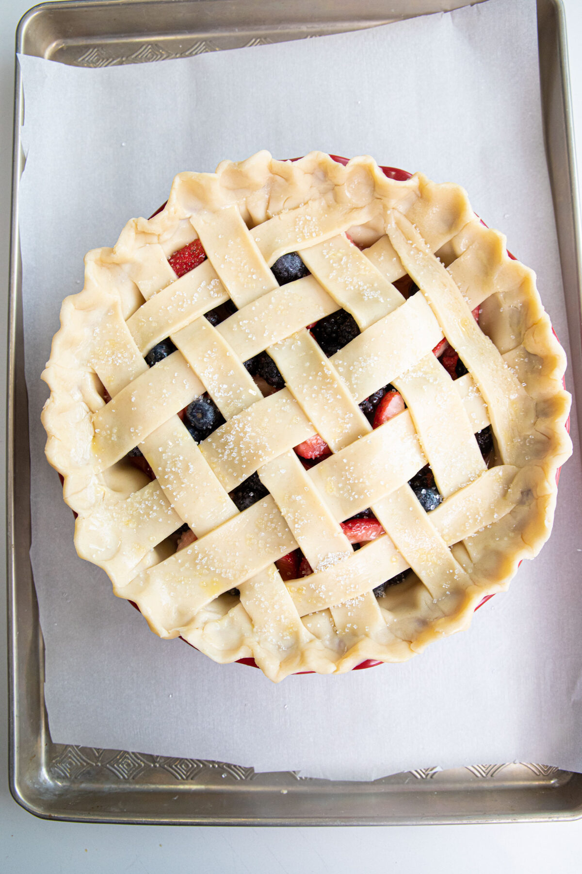mixed berry pie with lattice crust ready to bake