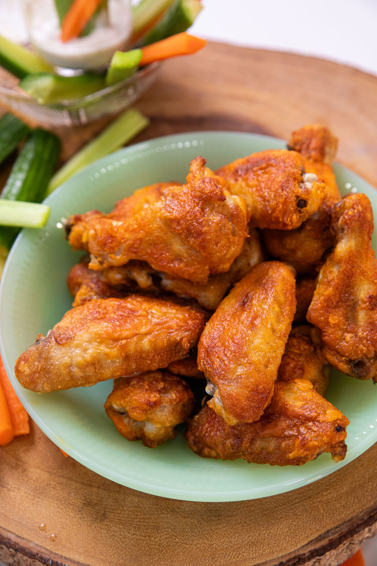 baked buffalo wings with sliced vegetables