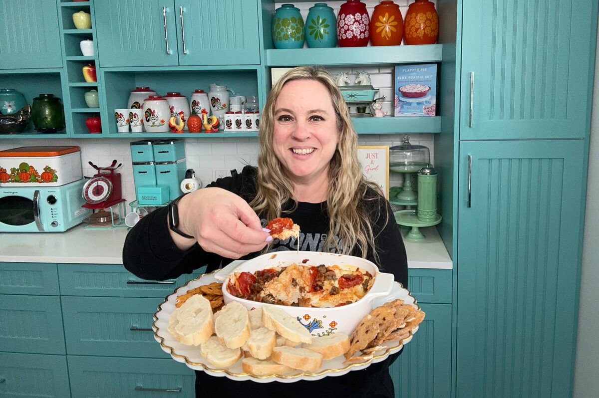 Karlynn holding a dish of her meat lover's pizza dip